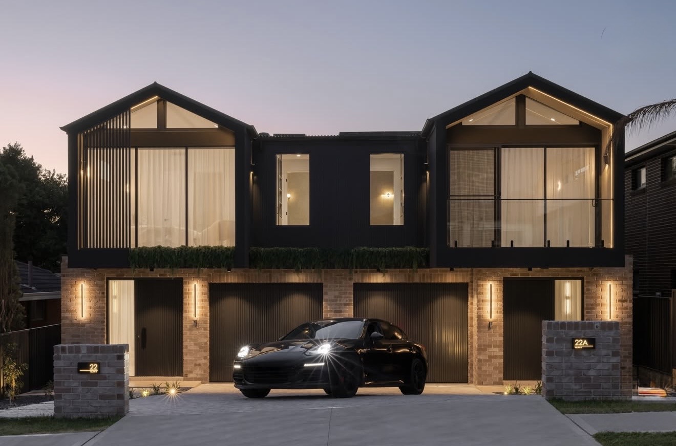 Architecturally designed dark-facade residence at dusk