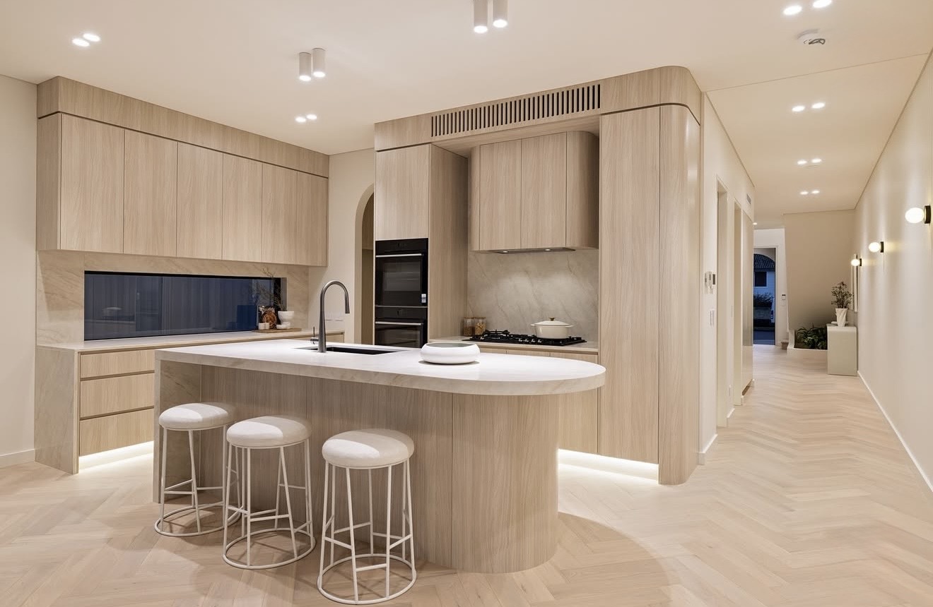 Light timber kitchen with integrated sink and concealed services