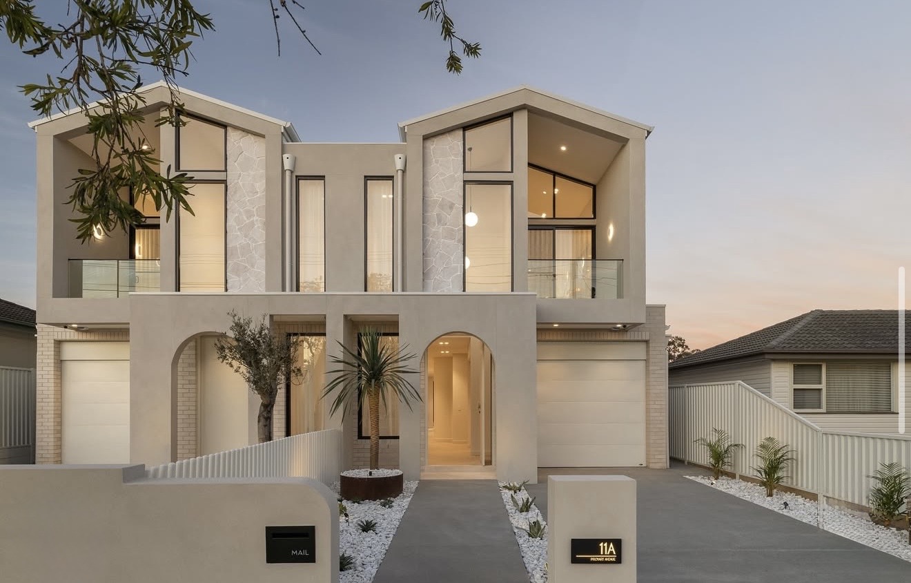 Contemporary white residence exterior at dusk
