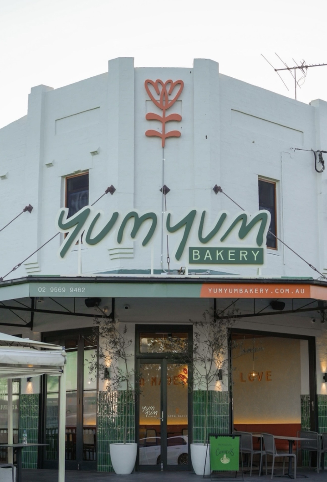 Yum Yum Bakery corner shopfront exterior with signage and tiled facade